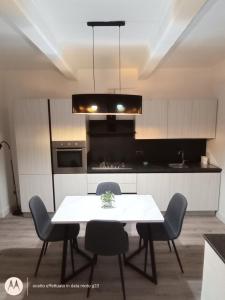 a kitchen with a white table and chairs in it at Irisapartment in Reggio di Calabria