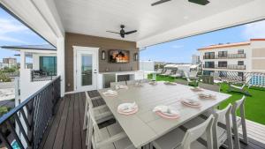 a patio with a table and chairs on a deck at The Pearl in Clearwater Beach