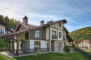 a large house in the mountains with a yard at CHALET NEBO in Bukovel