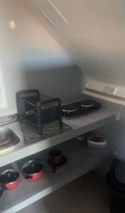 a kitchen with a stove top oven next to a sink at Condomíno dos Chalés in Porto Seguro +5 photos