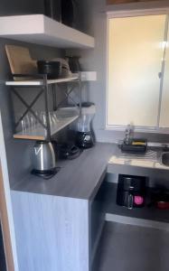a kitchen with a counter top with a counter top at Condomíno dos Chalés in Porto Seguro