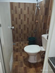 a bathroom with a toilet and a shower at RenSea Haven Boracay in Boracay