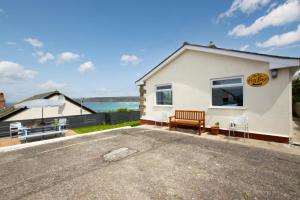 a building with a bench and a table and an umbrella at 3 Bed in Sennen Cove oc-p00781 in Sennen