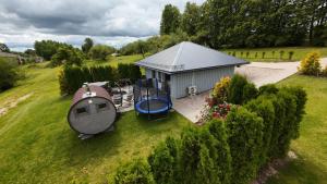 an overhead view of a shed with a playground at ''Ābeļdārza māja'' in Āboliņi