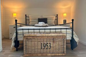 a bedroom with a wrought iron bed with a wickerasket at chalet with swimming pool in leisure park in Gujan-Mestras