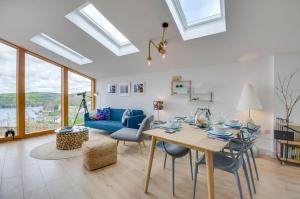 a living room with a table and a blue couch at 2 Bed in Polruan oc-p00896 in Polruan