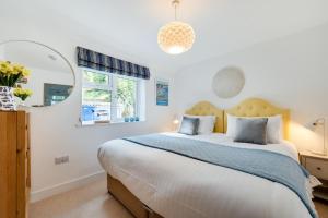 a bedroom with a large bed and a window at 2 Bed in Polruan oc-p00896 in Polruan