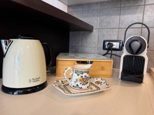 a tea kettle and a plate on a kitchen counter at Nido Alpino - casetta con giardino, vista montagne in Tirano