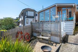 a small house with a wooden fence and a bench at 2 Bed in Polruan oc-p00896 in Polruan