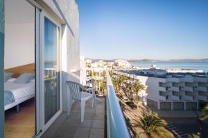 a balcony with a bed and a view of the ocean at Blanca by Uephotels in Can Picafort
