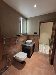 a bathroom with a toilet and a sink at ANVI Homestay in Bhopal +10 photos