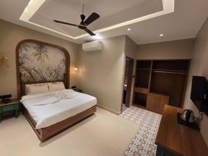 a bedroom with a bed and a ceiling fan at ANVI Homestay in Bhopal