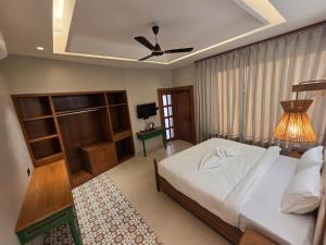 a bedroom with a bed and a ceiling fan at ANVI Homestay in Bhopal