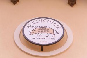 a sign on a wall with a cake on it at Albergo Al Cinghiale in Montevecchio