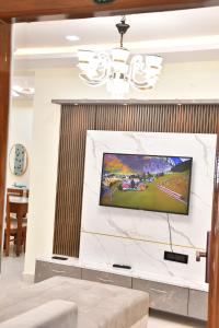 a living room with a flat screen tv on a wall at Beach front flat in Bhīmunipatnam +3 photos
