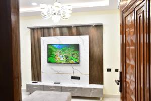 a living room with a tv on a wall at Beach front flat in Bhīmunipatnam