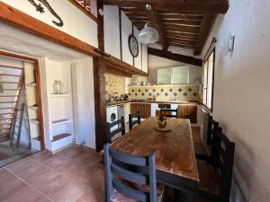 a kitchen with a wooden table and chairs at Le Gite des Anges du Verdon in Trigance