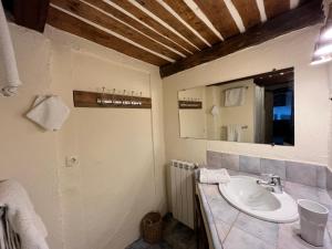 a bathroom with a sink and a mirror at Le Gite des Anges du Verdon in Trigance