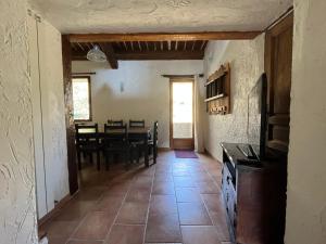 a kitchen and dining room with a table and chairs at Le Gite des Anges du Verdon in Trigance +4 photos