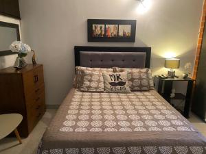 a bedroom with a bed with a pillow and a dresser at Reservas del peñon in Girardot +16 photos