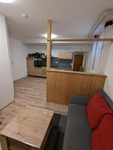 a living room with a couch and a table at Souterrainwohnung in Kelheim +4 photos