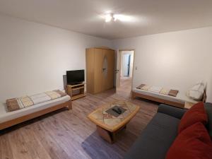 a living room with a couch and a tv at Souterrainwohnung in Kelheim