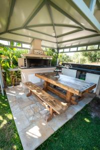 a picnic table under a tent with a stove at Romanza Luxury Villa in Kalamaki