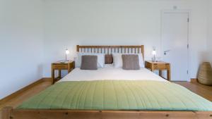 a bedroom with a large bed with two night stands at Bath Cottage in Caernarfon