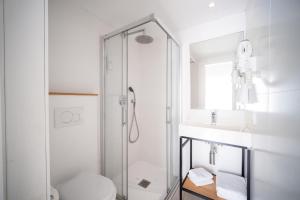 a bathroom with a shower and a toilet and a sink at Blanca by Uephotels in Can Picafort +45 photos