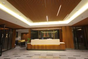 a lobby with a reception desk in a building at Sarju Palace in Valsād