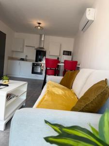a living room with a white couch and red chairs at Le Verger in Alixan +15 photos