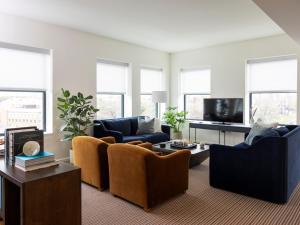 a living room with couches and a tv at The Study at Johns Hopkins in Baltimore