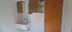 a small kitchen with a sink and cabinets at Depto 75m 2 dormitorios Frente al Parque Central con Cochera en el Centro denMendoza in Mendoza +93 photos