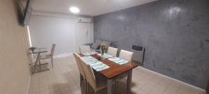 a dining room with a wooden table and chairs at Depto 75m 2 dormitorios Frente al Parque Central con Cochera en el Centro denMendoza in Mendoza