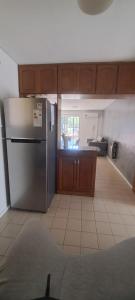 a kitchen with a stainless steel refrigerator in a room at Depto 75m 2 dormitorios Frente al Parque Central con Cochera en el Centro denMendoza in Mendoza