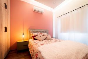 a bedroom with a bed and a lamp on a night stand at Katherine's Village House in Ayios Ioannis +6 photos