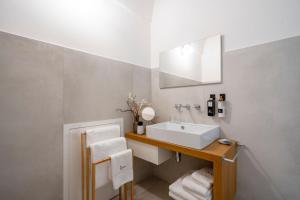 a bathroom with a sink and a mirror at Dimora Sardaro Suites by BarbarHouse in Monopoli +7 photos