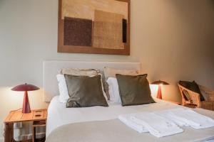 a bed with white sheets and pillows in a bedroom at Impar Studios in Porto