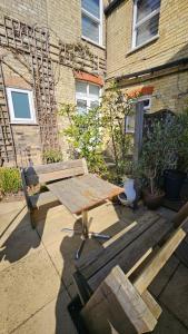 a picnic table and a bench in front of a building at Worth House in Cambridge
