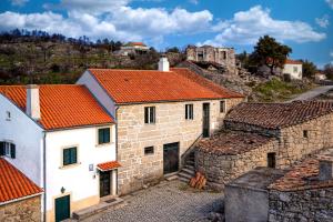 an overview of a village with orange roofs at Casa do Miradouro in Guarda +4 photos