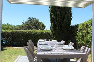 a white table with white dishes on it at Quinta dos Crastos Pool House in Porches