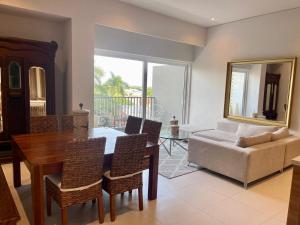 a living room with a table and a couch at New 2 bedroom rooftop condo in Nuevo Vallarta +18 photos