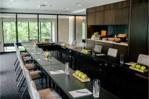 a restaurant with long tables and chairs and a bar at The Study at Johns Hopkins in Baltimore