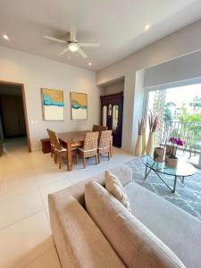 a living room with a couch and a table at New 2 bedroom rooftop condo in Nuevo Vallarta