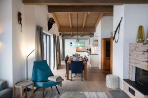 a kitchen and living room with a table and chairs at Kristall Plaza in Niederau