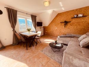 a living room with a couch and a table at Hotel zum Anker in Detzem