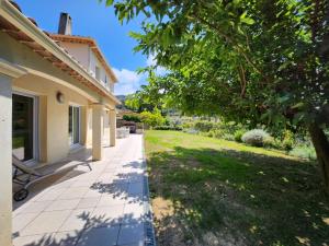 a walkway to a house with a yard at happyfew villa laghet in La Trinité