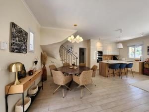a dining room and kitchen with a table and chairs at happyfew villa laghet in La Trinité