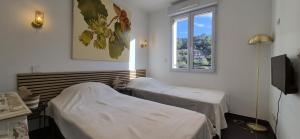 a hospital room with two beds and a window at happyfew villa laghet in La Trinité +7 photos