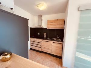 a kitchen with a sink and a counter top at Hotel zum Anker in Detzem +36 photos